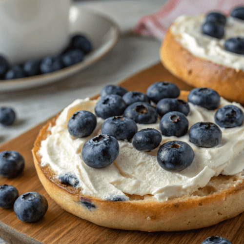 oasted blueberry bagel with cream cheese and fresh berries