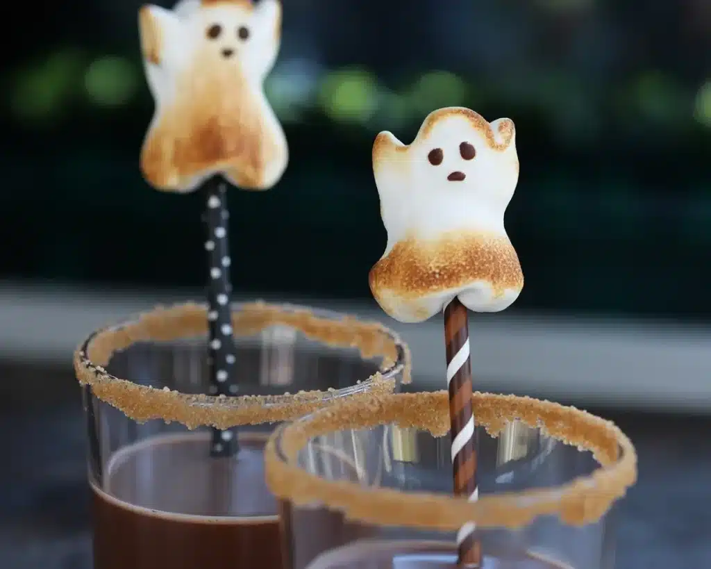 Delicious Halloween candy s'mores with spooky decorations and flavors.