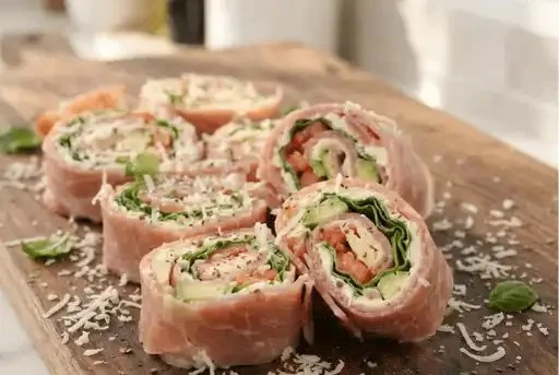 Delicious low-carb pinwheels with cream cheese and avocado on a serving platter.