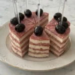 Savory cheese and salami cake slices served on a platter for a party