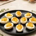 Spooky skull deviled eggs for Halloween party decoration