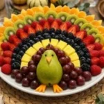 Colorful turkey fruit platter designed for kids' healthy snacks and Thanksgiving celebrations.
